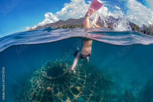 Woman snorkeling underwater,Â Perebutan, Bali, Indonesia photo