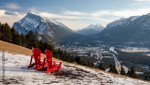 Two red chairs overlooking distant town, Alberta, Canada