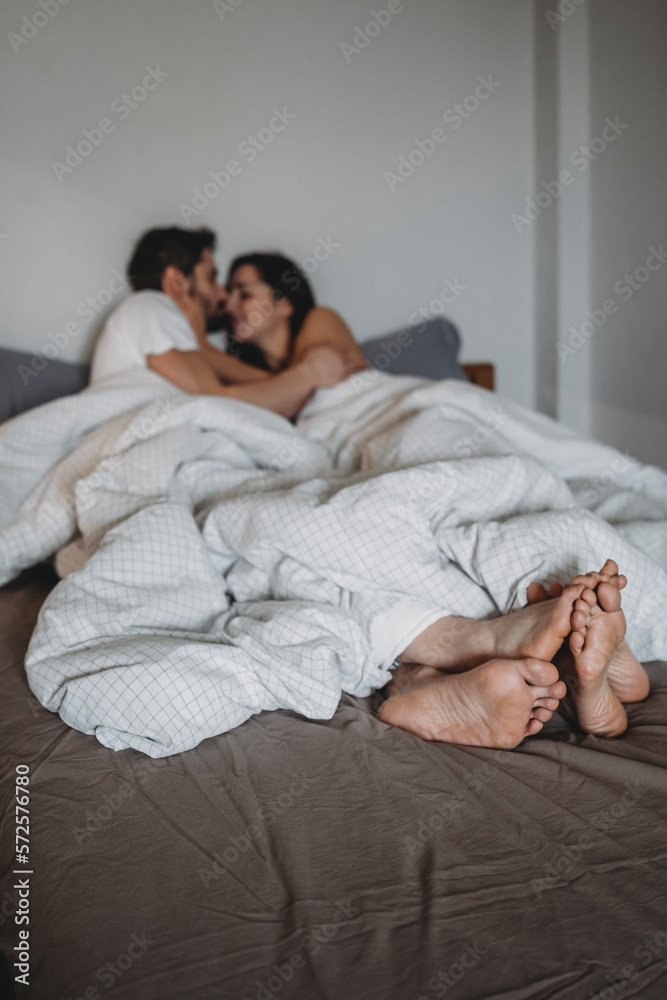 Young loving couple in the bed in the morning