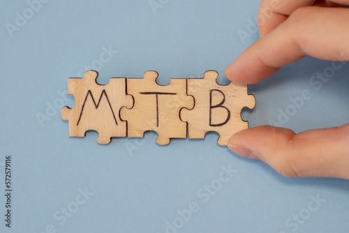 MTB acronym word written on wooden puzzles mycobacterium tuberculosis on a blue background photo