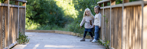 Couple of cute smiling toddlers having fun outdoors