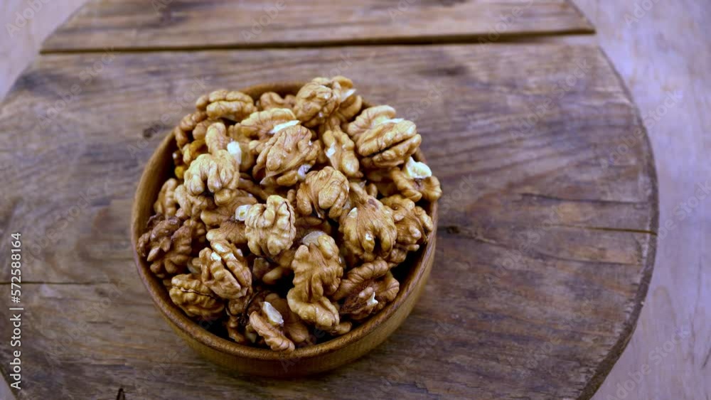 Nuts in a bowl. Healthy food top view. Nut without shell on a plate. Whole and half walnuts kernels. Peeled walnut. Nuts in a bowl. Healthy food top view. Nut without shell on a plate. Whole and half walnuts kernels. Peeled walnut.