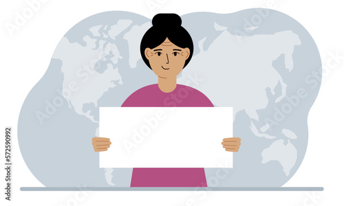 The concept of world attention. A woman holds a white poster in his hands against the background of a world map.