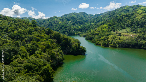 Aerial drone of lake among mountains with tropical forest. Lake Balanan. Negros, Philippines