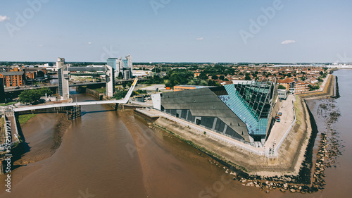 Hull City drone image including the Deep aquarium, and the tidal barrier at the crossing point of the Humber Estuary and the River Hull. Industrial and pier near the old town. photo