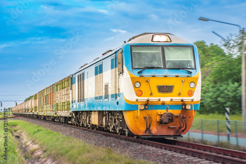 Freight train by diesel locomotive passed the railway station.