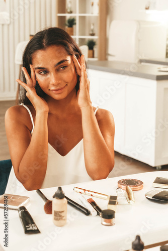young woman sitting in front of mirror at home photo