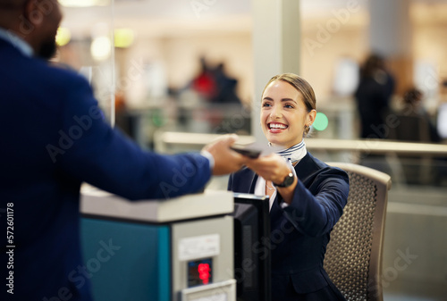 Woman, airport and service agent with passport helping traveler for check in at terminal counter. Female passenger assistant with smile in travel security or immigration documents for airline control
