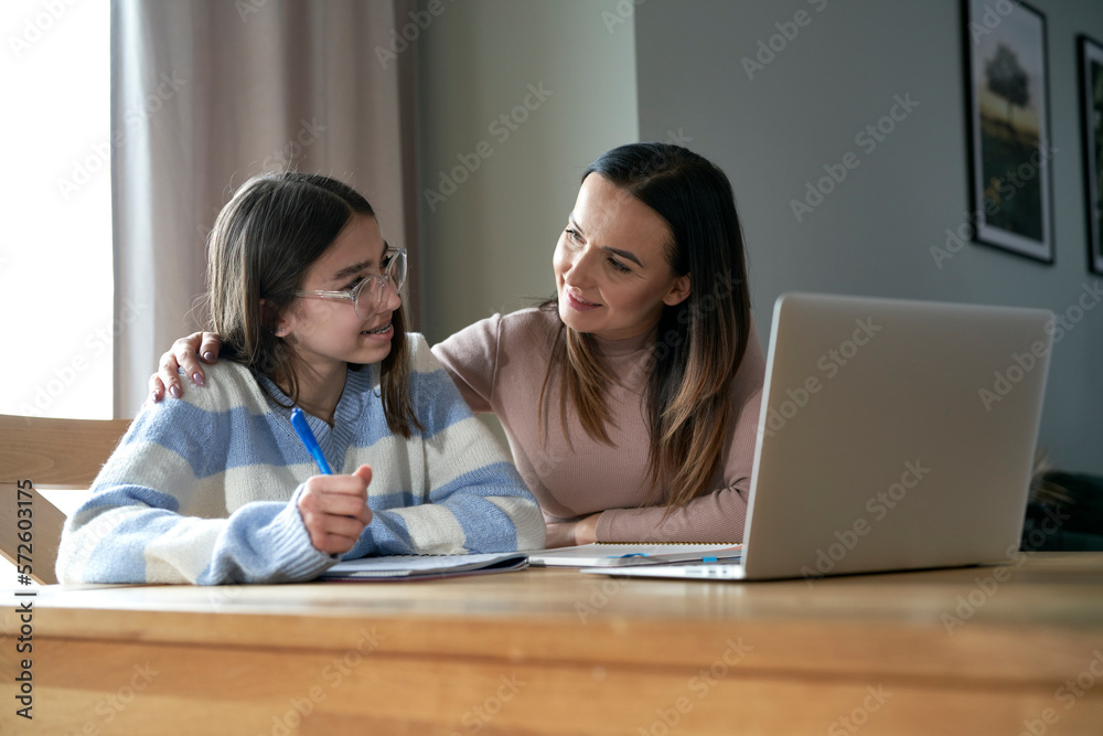 Caucasian mother with teenager daughter make homework at home Caucasian mother with teenager daughter make homework at home