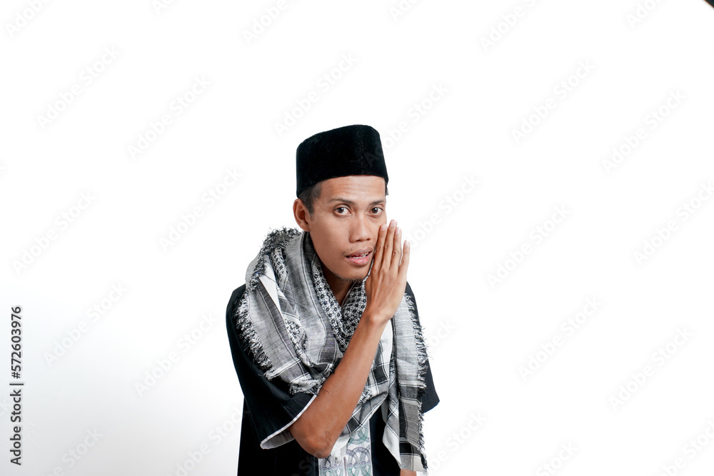 Religious muslim asian man wearing turban, muslim dress and cap. While giving info in a whisper, hands near mouth. isolated on white background. Religious muslim asian man wearing turban, muslim dress and cap. While giving info in a whisper, hands near mouth. isolated on white background.