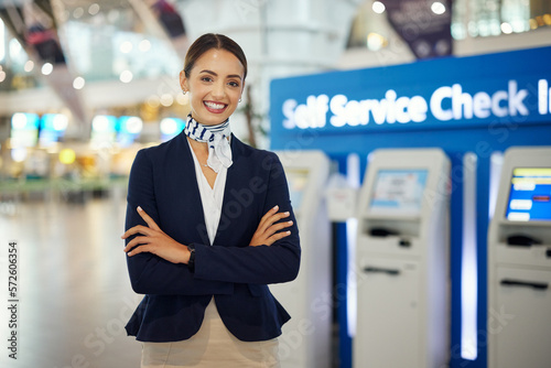 Wallpaper Mural Woman, passenger assistant and arms crossed at airport by self service check in station for information, help or FAQ. Portrait of happy female services agent standing ready to assist people in travel Torontodigital.ca