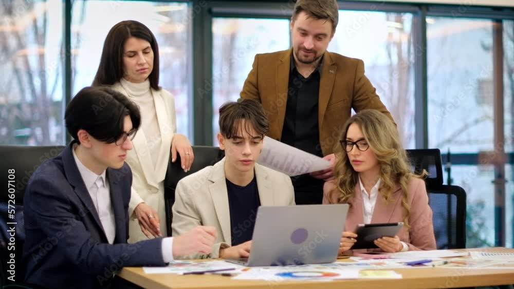 Business meeting in an office, workers discussing business affairs using gadgets and papers Business meeting in an office, workers discussing business affairs using gadgets and papers