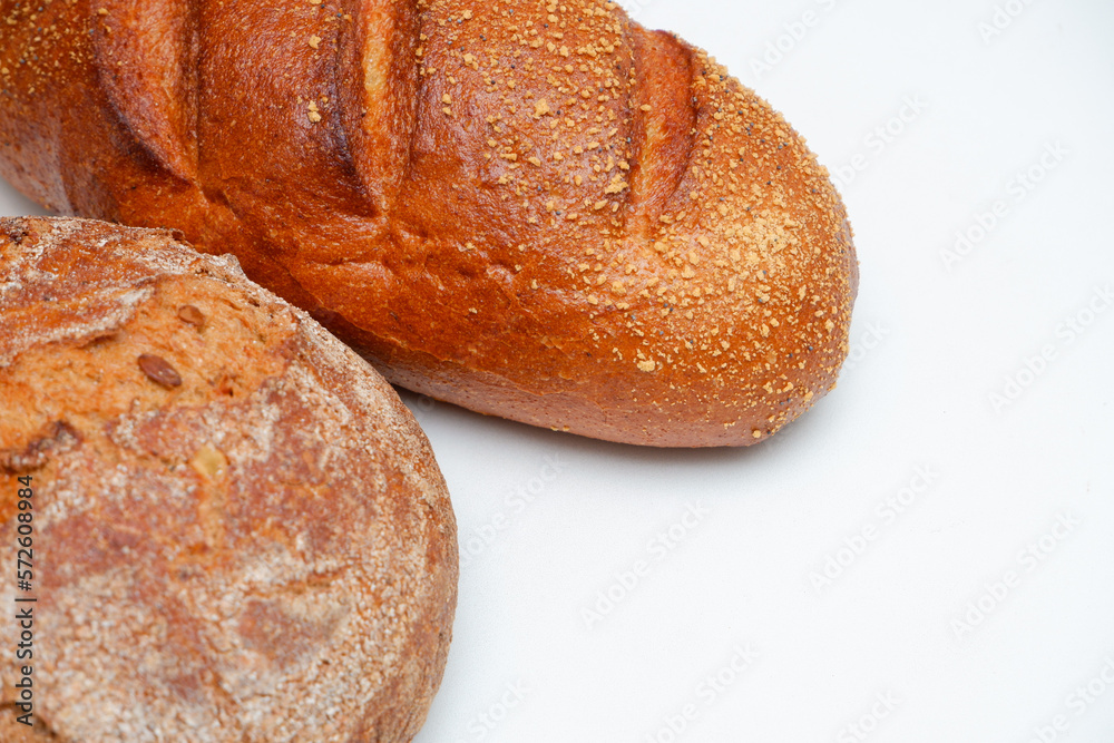 Close-Up Of Bread On White Background. Food, baking and cooking concept - close up of bread