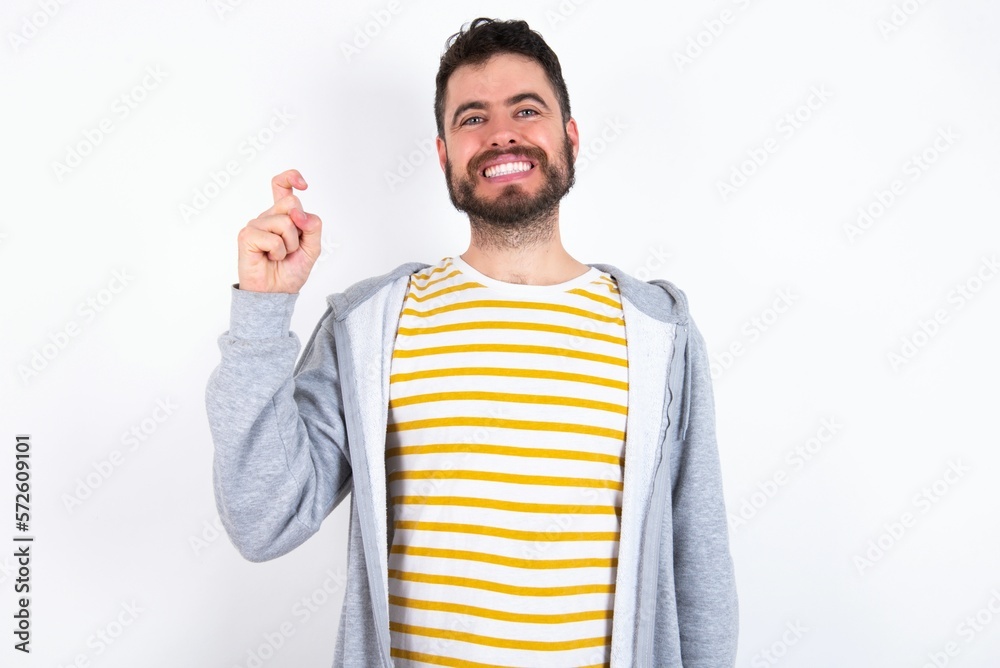 caucasian man wearing casual sportswear over white wall pointing up with fingers number nine in Chinese sign language Jiu caucasian man wearing casual sportswear over white wall pointing up with fingers number nine in Chinese sign language Jiu