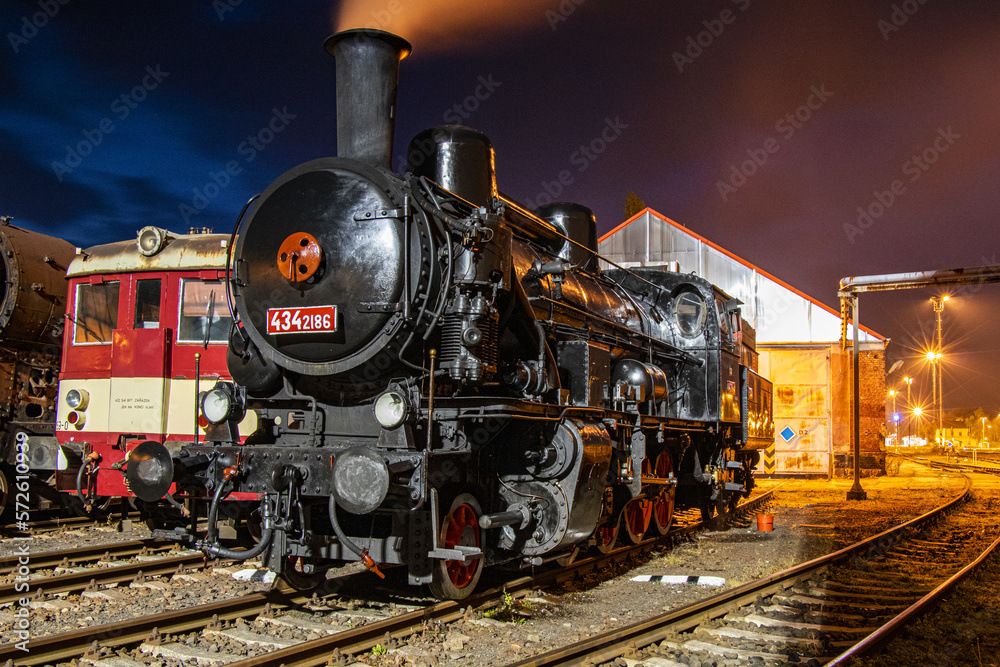 Naklejka premium nighttime waiting of a historic steam locomotive for a new train