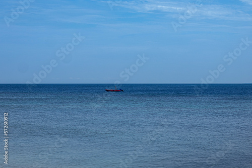 ocean surface and boat with blue horizon indonesia © matthias