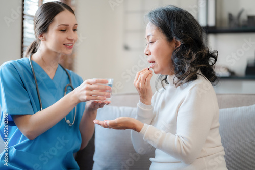 Young female therapist consulting female patient about pills. Doctor prescribing medicine sitting at the sofa in the clinic.