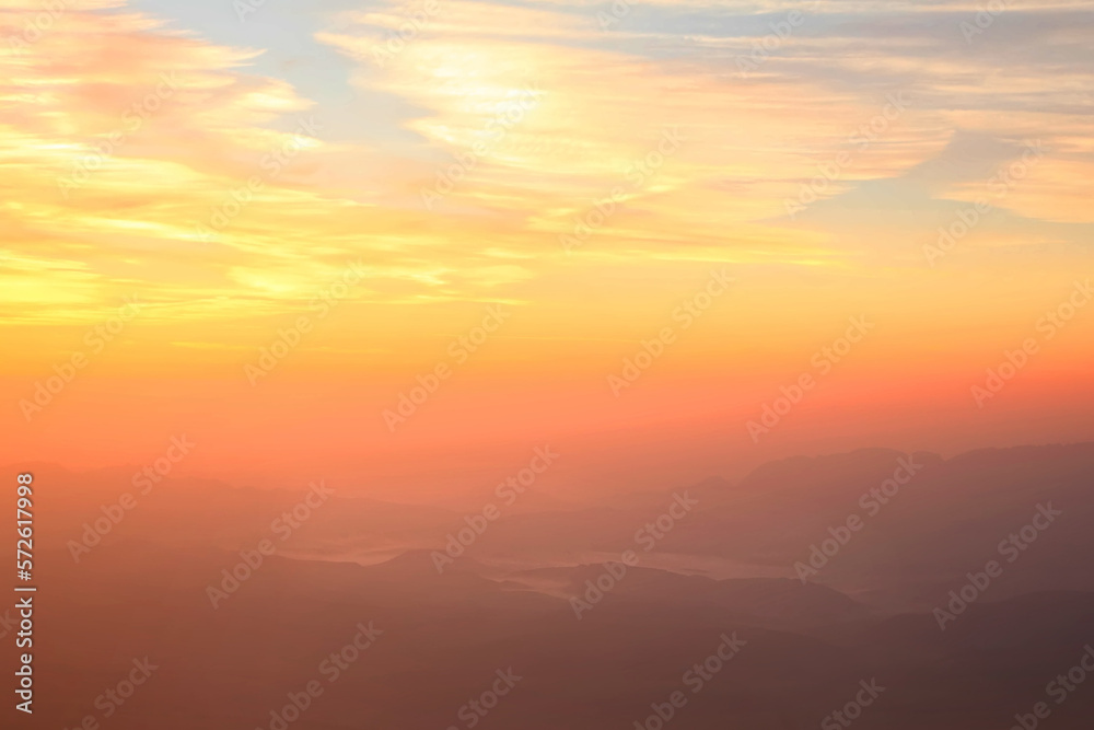 Sunrise sky over the foggy mountains in the wild. Wonderful world. Environment protection Sunrise sky over the foggy mountains in the wild. Wonderful world. Environment protection