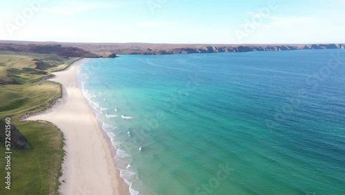 Tilting drone shot from the headland and sheer cliffs to the northern terrain at Traigh Mhor beach in Tolsta village on the Outer Hebrides of Scotland. photo