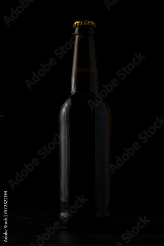 A bottle of beer on a black background