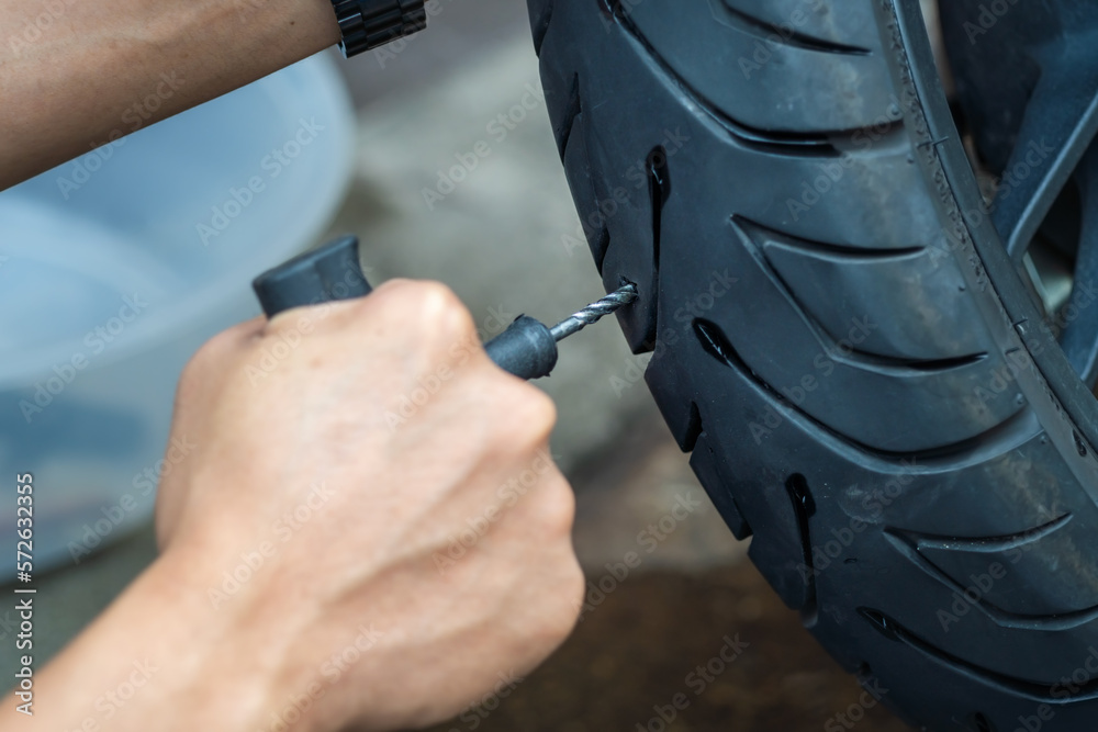 Rider use a tire plug kit and trying to fix a hole in tire's sidewall