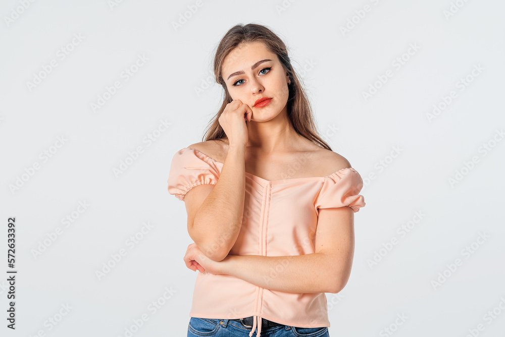 Fototapeta premium Bored and lazy people. Young brunette woman wearing casual clothes, thinking, looking tired and bored with depression problems, standing over white background