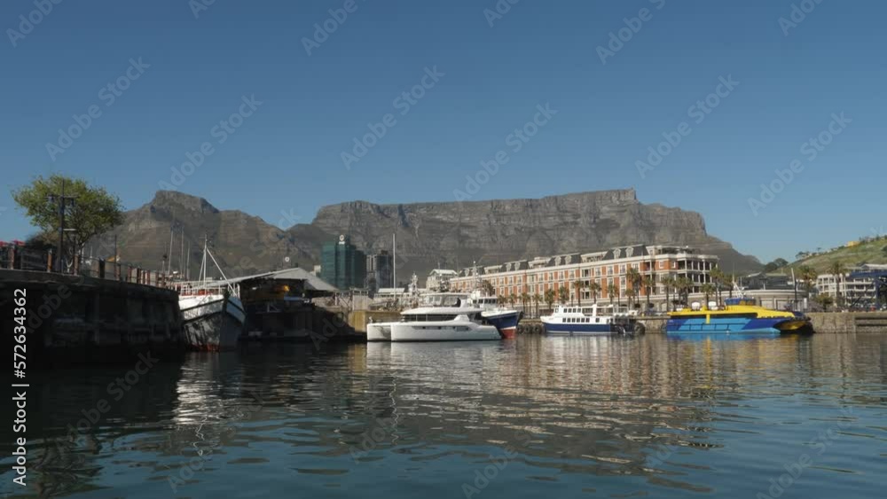 Smooth boating POV: Cape Town harbour piers with Table Mountain beyond Smooth boating POV: Cape Town harbour piers with Table Mountain beyond