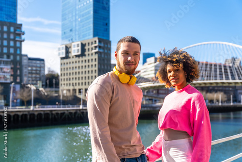 Multiracial friends on the streets of the city, lifestyle concept, portrait by the river