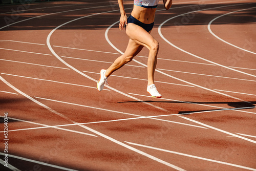 female athlete running on track of stadium