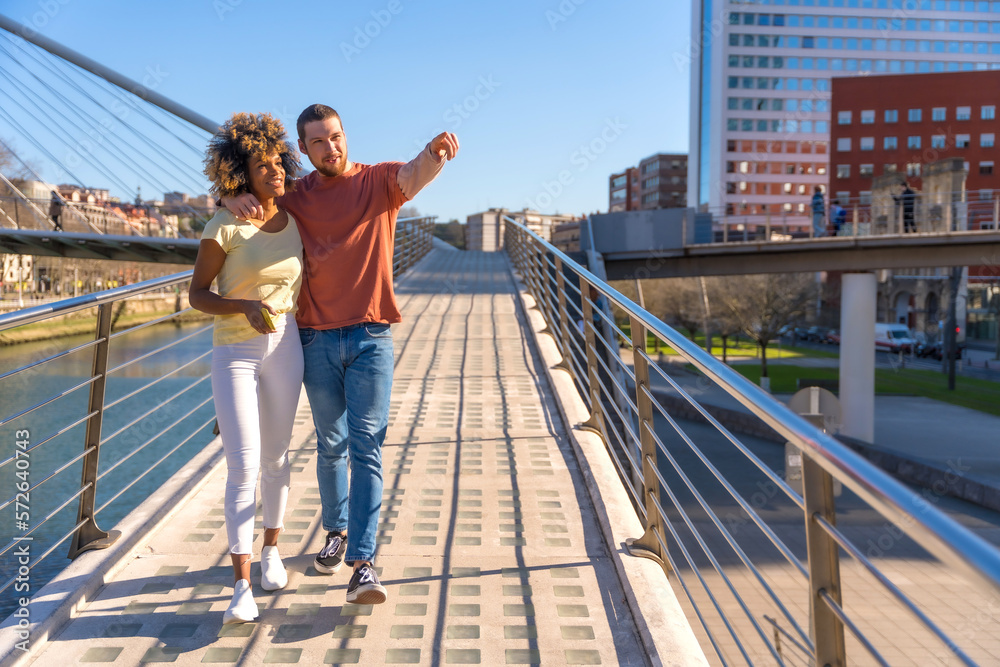 Multiracial couple through the streets of the city, lifestyle, embraced enjoyed the weekend Multiracial couple through the streets of the city, lifestyle, embraced enjoyed the weekend