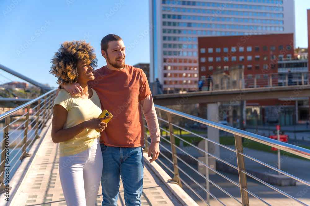 Multiracial couple through the streets of the city, lifestyle, embraced enjoyed the weekend Multiracial couple through the streets of the city, lifestyle, embraced enjoyed the weekend