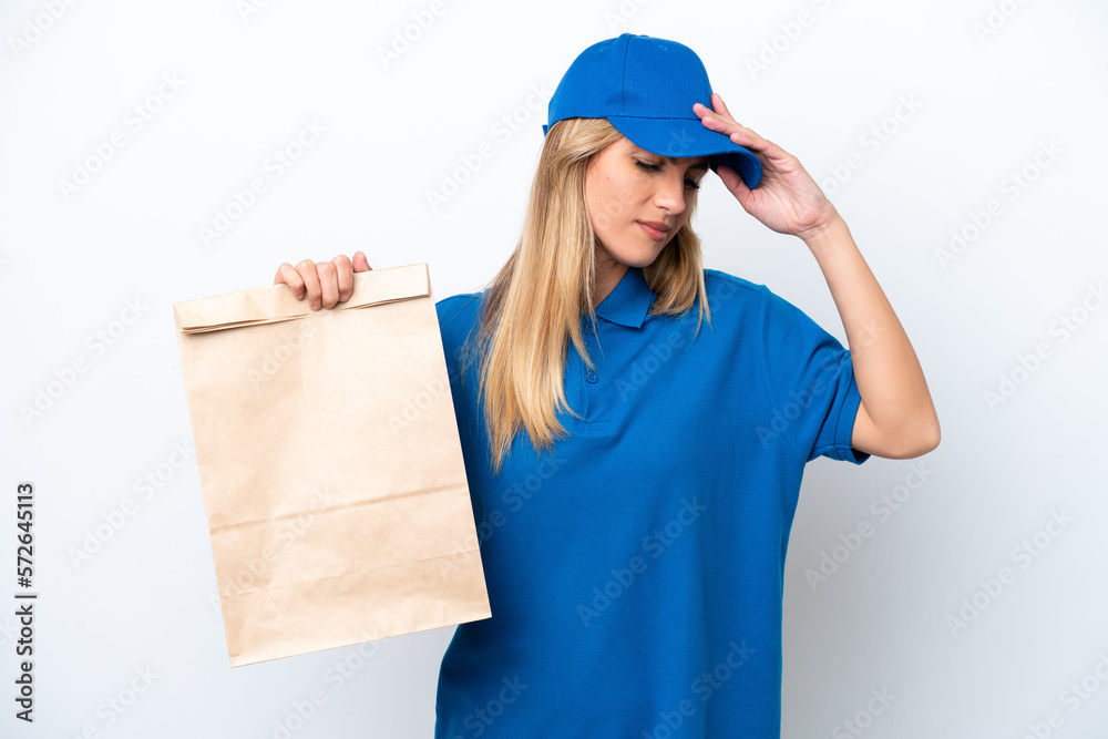 Young Uruguayan woman taking a bag of takeaway food isolated on white background with headache