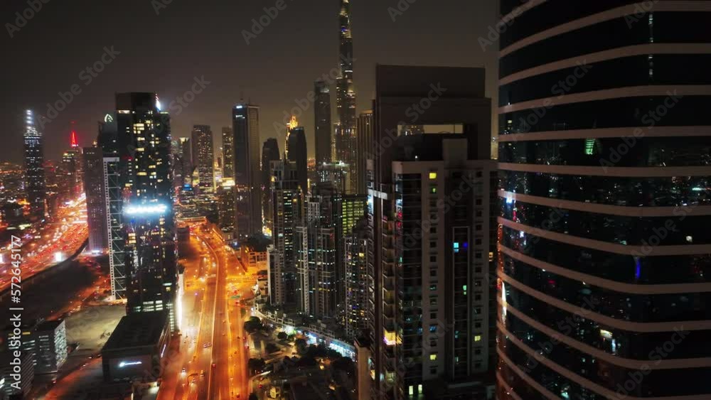 Cinematic drone shot of Downtown Dubai at night revealing skyline buildings, luxury hotels and properties
