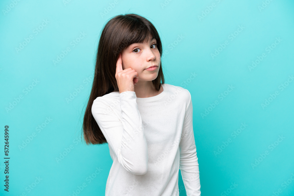 Little caucasian girl isolated on blue background thinking an idea Little caucasian girl isolated on blue background thinking an idea
