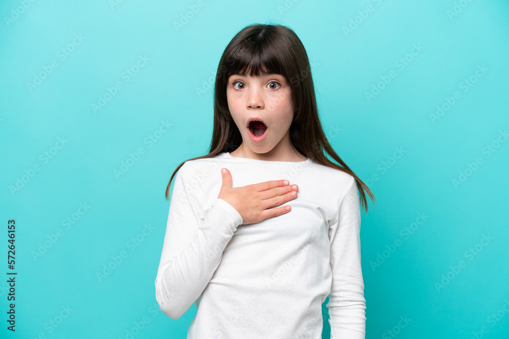 Little caucasian girl isolated on blue background surprised and shocked while looking right Little caucasian girl isolated on blue background surprised and shocked while looking right