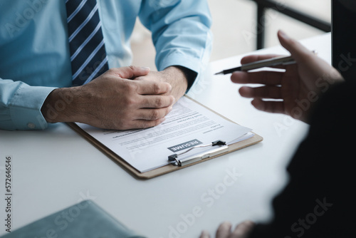 A person attends a job interview with a manager to join a company, he holds a resume and interview with information introducing himself and his ability to work. Job application concept.