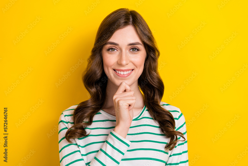 Portrait photo of cheerful satisfied smart positive woman touch chin creative plan genius solution clever idea isolated on yellow color background Portrait photo of cheerful satisfied smart positive woman touch chin creative plan genius solution clever idea isolated on yellow color background
