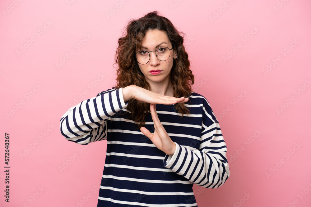 Young caucasian woman isolated on pink background making time out gesture Young caucasian woman isolated on pink background making time out gesture