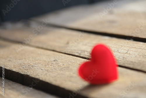 Red heart on a wooden background. Place for text. Valentine.