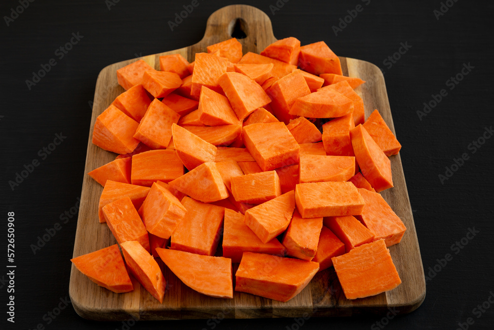 Raw Chopped Sweet Potatoes on a Cutting Board, low angle view.