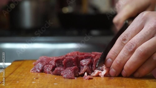 Rural cuisine. Cooking pork in a home country kitchen. Cut tenderloin for steak.