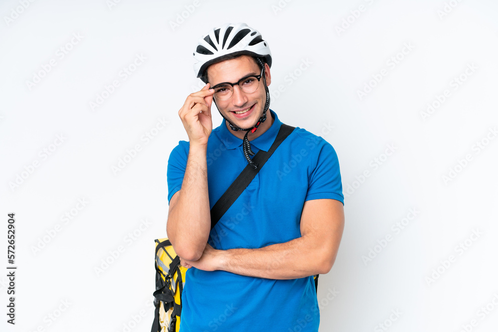Young caucasian man with thermal backpack isolated on white background with glasses and happy Young caucasian man with thermal backpack isolated on white background with glasses and happy