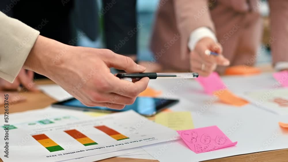 Business meeting in an office, close view of workers discussing business affairs using papers. Slow motion Business meeting in an office, close view of workers discussing business affairs using papers. Slow motion