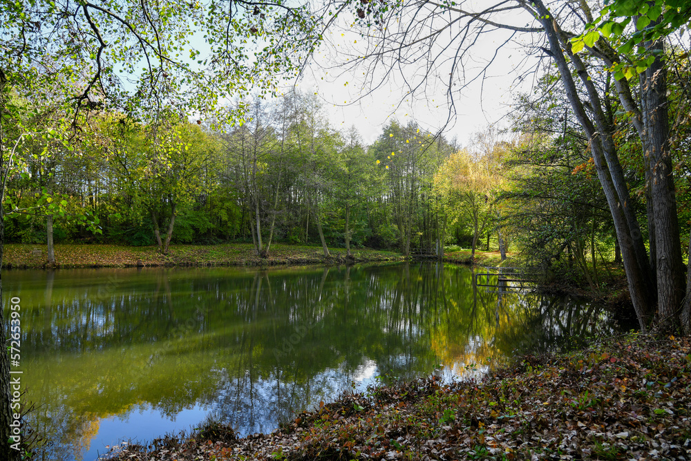 Ostheim natural bathing lake near Malsfeld. Idyllic landscape by the lake in autumn. 
