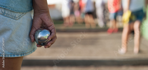 Fototapeta Naklejka Na Ścianę i Meble -  Senior playing petanque un and relaxing game. Senior woman prepared to throw the boules ball in a park in outdoor play