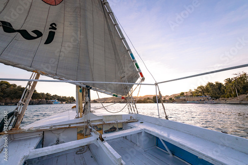 Felucca Sailing on the Nile River in Aswan. Popular Tourist Sailboat in the Nile. Aswan, Egypt. Africa.  © Curioso.Photography
