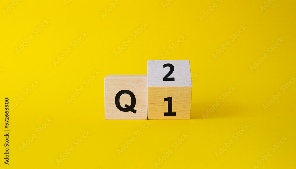 From 1st Quarter to 2nd symbol. Turned wooden cubes with words 1st Quarter and 2nd Quarter. Beautiful yellow background. Business and Quarter concept. Copy space From 1st Quarter to 2nd symbol. Turned wooden cubes with words 1st Quarter and 2nd Quarter. Beautiful yellow background. Business and Quarter concept. Copy space