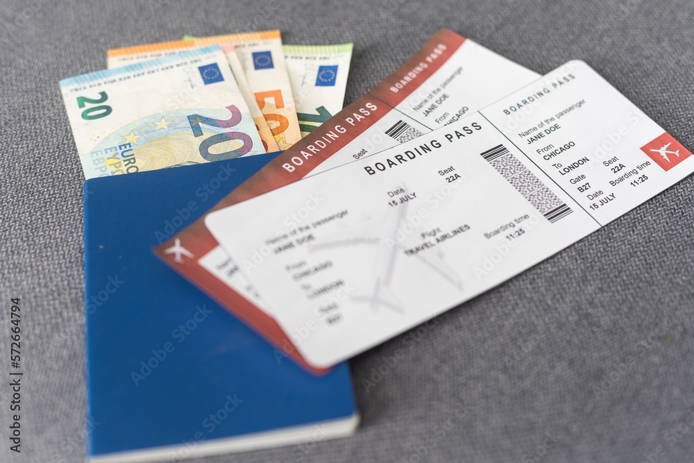Two tickets for plane with passports on gray background Two tickets for plane with passports on gray background
