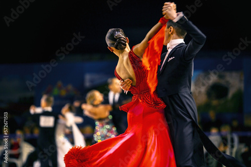 Fototapeta сouple dancers man and woman waltz dancing in competition