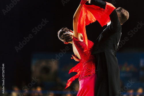 dancers man in black tailcoat and woman in red ball gown photo